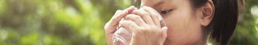 A girl drinking out of a glass